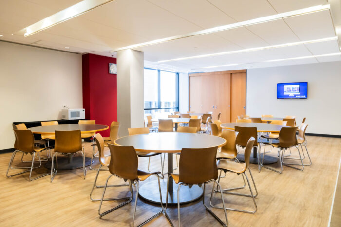 Schulich Executive education dining space with four round tables and chairs.